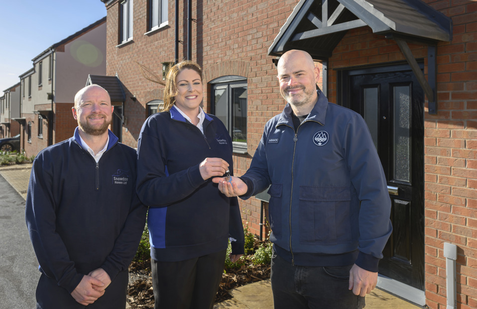 Group of three people with house keys