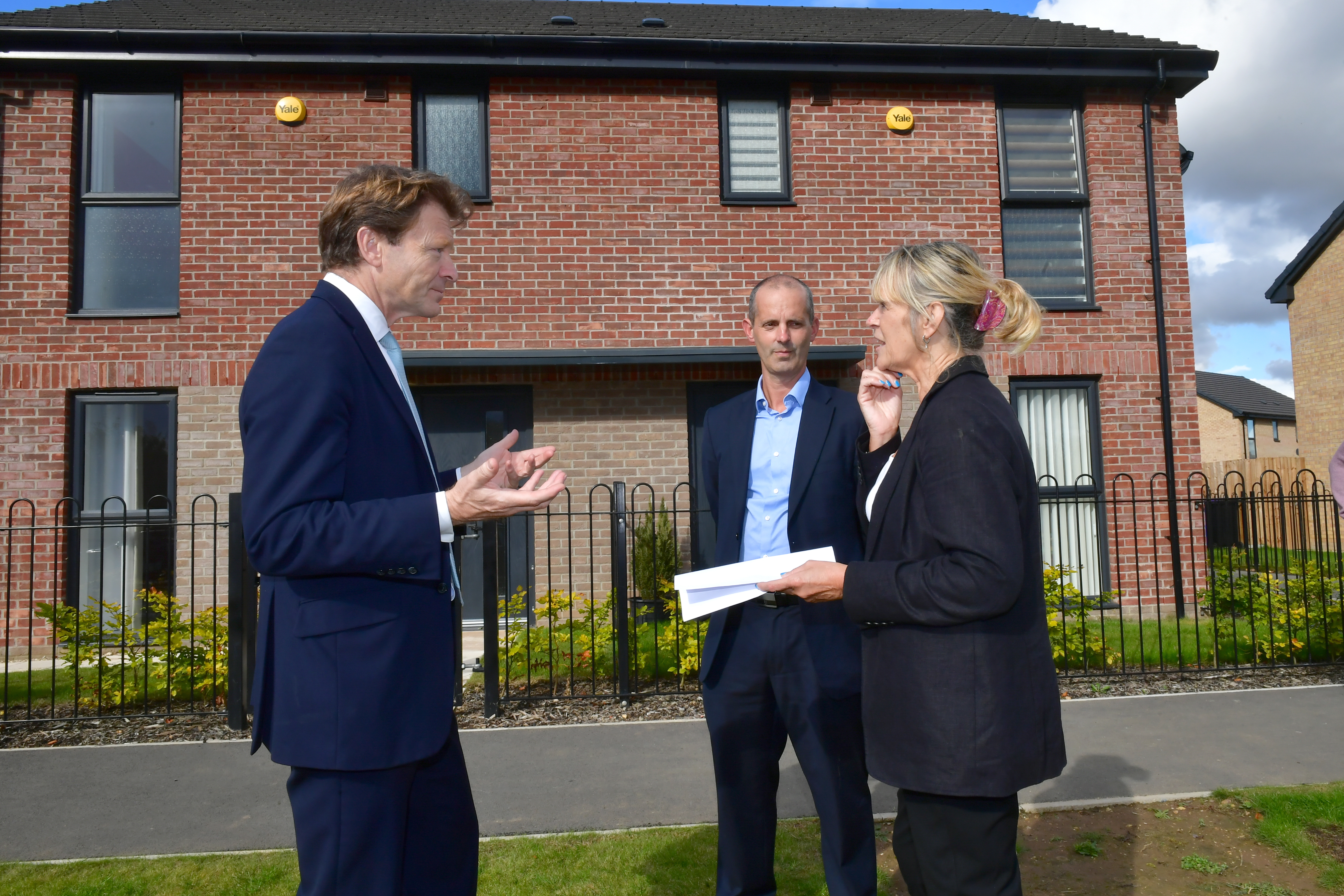 Man talking outside a new build home