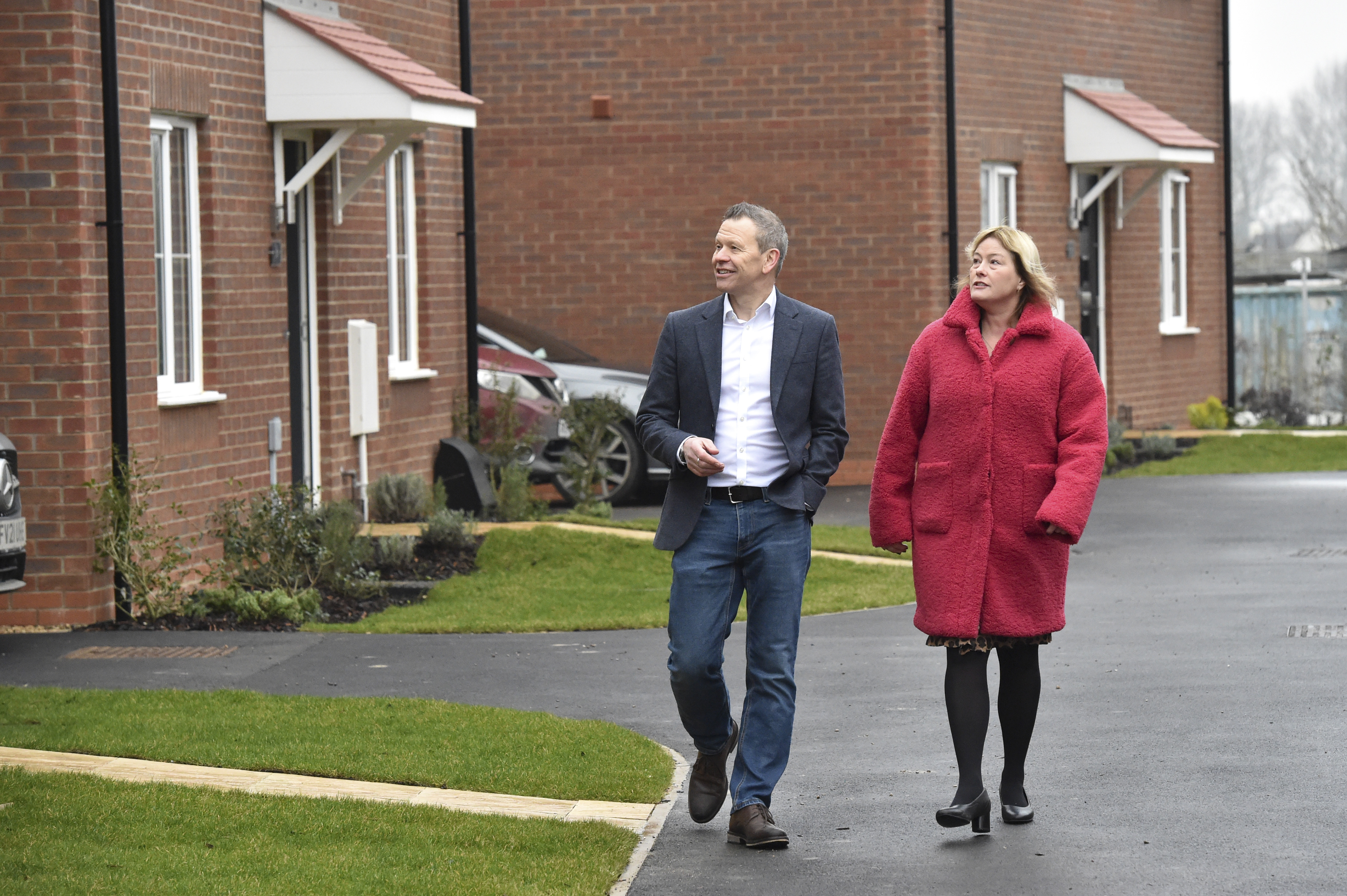 Two people walking around new development